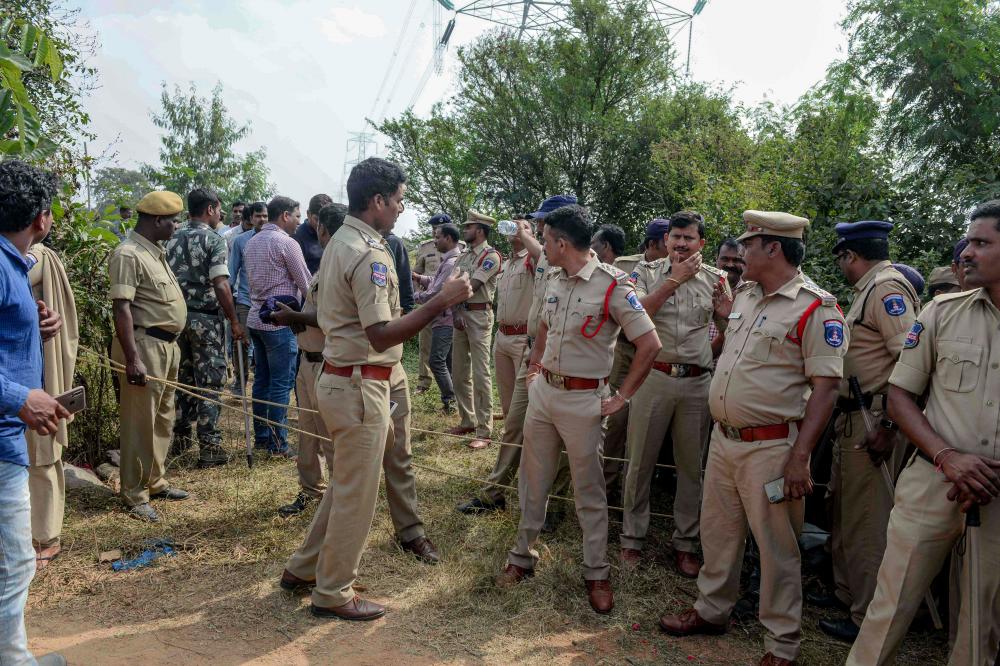 Police personnel stand near the site where they shot dead four detained gang-rape and murder suspects in Shadnagar on Dec 6, 2019. — AFP