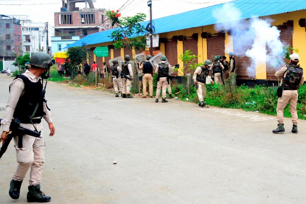 In this picture taken on May 4, 2023, security personnel fire tear gas whilst the Meitei community tribals protest to demand inclusion under the Scheduled Tribe category, in Imphal the capital of India’s Manipur state. AFPPIX