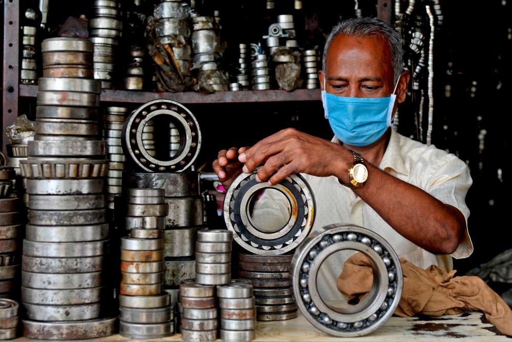 A shopkeeper displays bearings at a second hand automobile spare market in Chennai. Under new rules announced by India in April, all investments by entities based in neighbouring countries need to be approved by the government. – AFPPIX