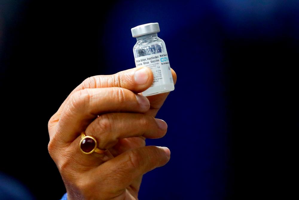 Indian Health Minister Harsh Vardhan holds a dose of Bharat Biotech's Covid-19 vaccine called Covaxin, during a vaccination campaign at All India Institute of Medical Sciences (AIIMS) hospital in New Delhi, India, January 16, 2021. REUTERSPix