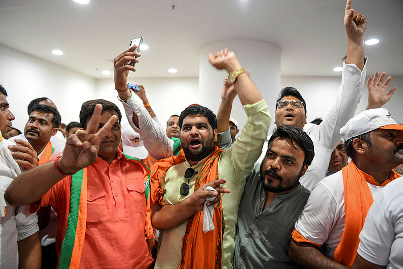Indian Bharatiya Janata Party (BJP) supporters shout slogans as they celebrate on the vote results day for India’s general election in New Delhi on May 23, 2019. — AFP