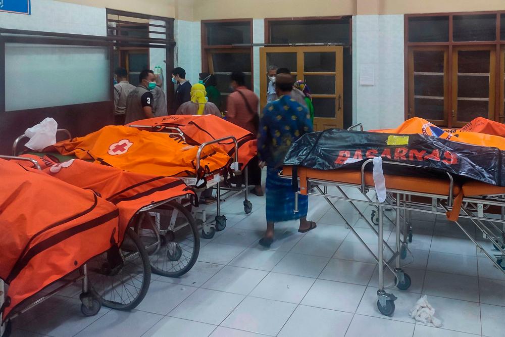 Relatives of students, who drowned while participating in a trekking activity of a scout group along the Cileuleur River, leave the morgue of a regional hospital in Ciamis on October 15, 2021. AFPpix