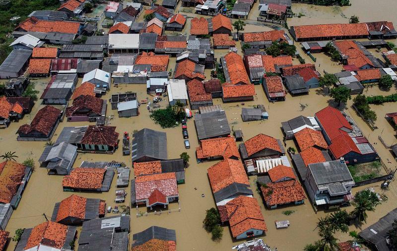 An aerial picture shows a flooded residential area after some rivers overflowed following heavy rain in Bekasi, a suburb of Jakarta, on March 5, 2025. - Aditya Irawan / AFP