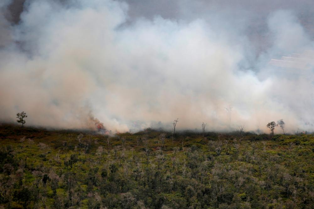 Smoke covers a forest during fires near Banjarmasin in South Kalimantan province, Indonesia, September 29, 2019. — Reuters