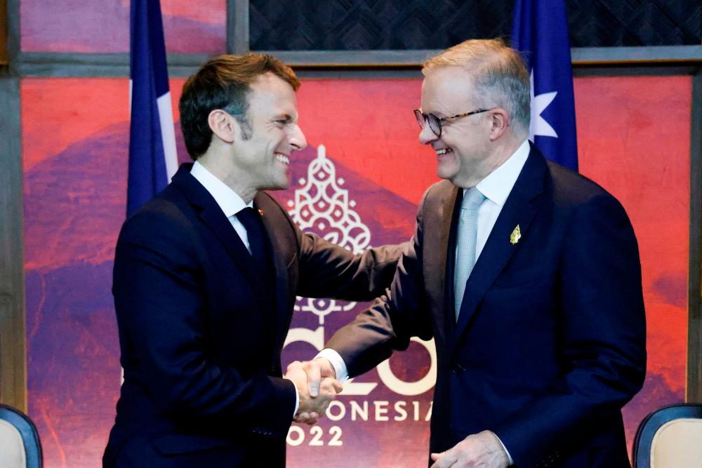 France’s President Emmanuel Macron (L) meets Australia’s Prime Minister Anthony Albanese on the sidelines of the G20 Summit in Nusa Dua on the Indonesian resort island of Bali on November 16, 2022. AFPPIX