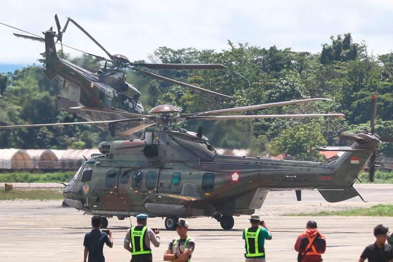 Indonesian Air Force helicopters take off as they evacuate the body of a New Zealand helicopter pilot at Mozes Kilangin Airport in Timika - AFPpix