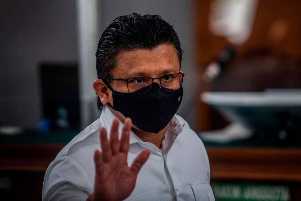 Former head of the internal affairs for Indonesia’s national police Ferdy Sambo, who is accused of murdering bodyguard Nofriansyah Yosua Hutabarat, gestures as he arrives for a verdict hearing at the South Jakarta court in Jakarta on February 13, 2023/AFPPix