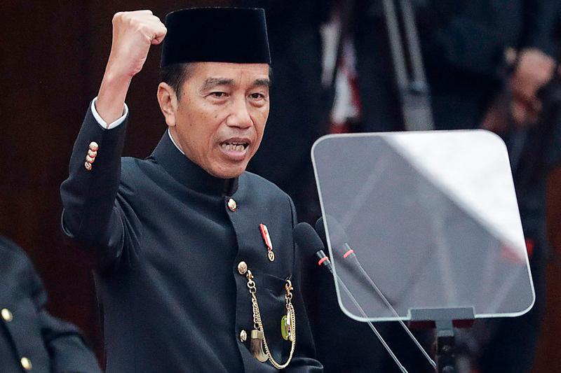 Indonesia's President Joko Widodo, wearing traditional Betawi attire, delivers his annual state of the nation address at the parliament building in Jakarta on August 16, 2024. - Bagus INDAHONO / POOL / AFP