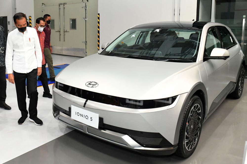 March 17, 2022 -- Indonesia’s President Joko Widodo (L) visiting a Hyundai factory which produces the electric car “Ionic 5” in Bekasi, West Java. AFPPIX