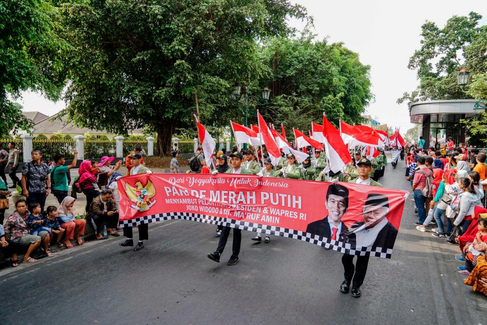 Indonesians take part in a parade to celebrate the upcoming inauguration of President Joko Widodo's second term in Jakarta on October 19, 2019. - AFP