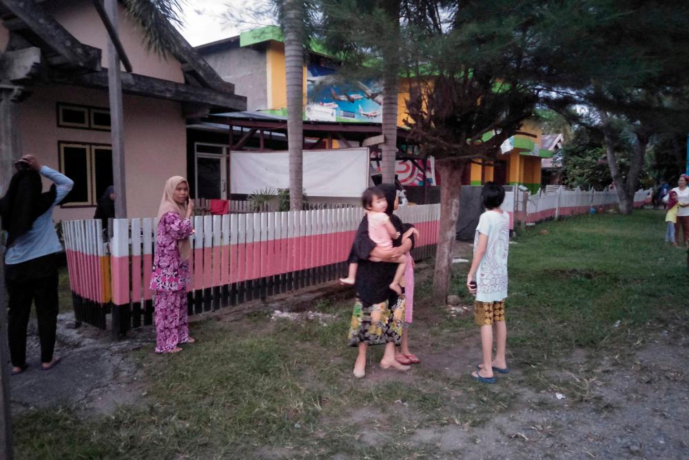 Indonesian people stay out of their homes following 7.3 magnitude earthquake in Labuha, North Maluku on July 14, 2019. — AFP