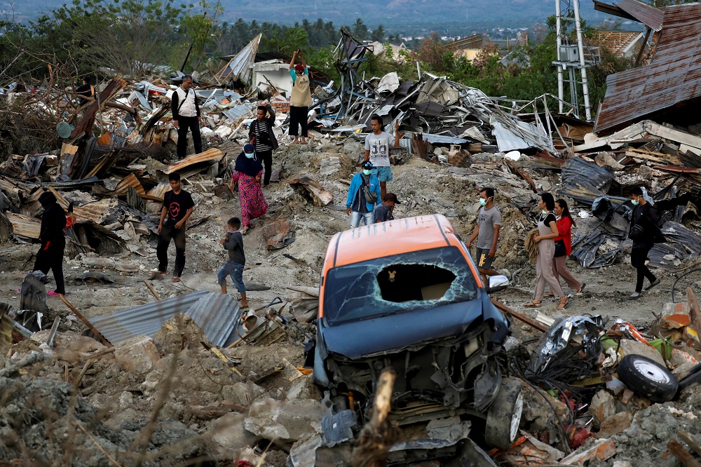 People walk at Petobo neighbourhood which was hit by an earthquake and liquefaction in Palu, Central Sulawesi, Indonesia, on Oct 8, 2018. — Reuters