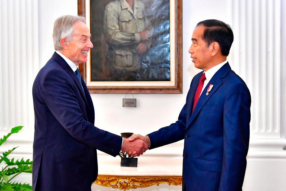 This handout picture taken and released on April 18, 2024 by Indonesia’s presidential palace shows Indonesian President Joko Widodo (R) meeting with former British Prime Minister Tony Blair at the Merdeka Palace in Jakarta/AFPPix