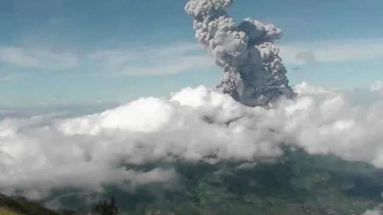 This handout photo taken and released on June 21, 2020 by Indonesia’s Research and Technology Development for Geological Hazard Mitigation (BPPTKG) shows the Merapi Mount volcano spewing thick smoke into the air as seen from Yogyakarta. — AFP