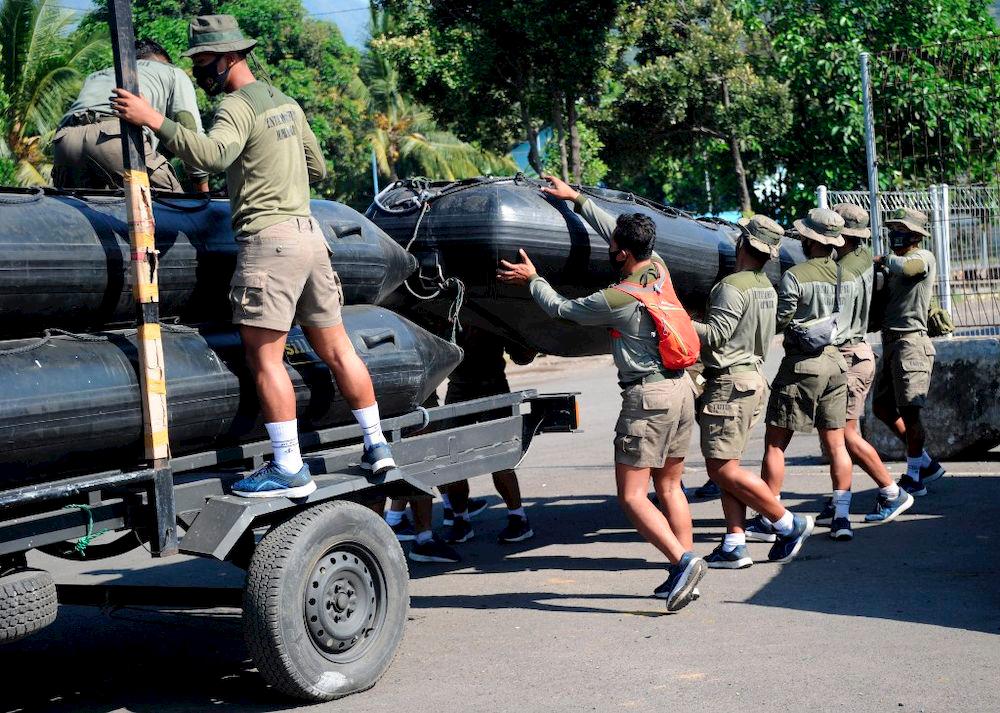 Members of an Indonesian marine amphibious reconnaissance squad prepare equipment for search operations at the Tanjungwangi port near the naval base in Banyuwangi, East Java province on April 25, 2021, as the military continues the search off the coast of neighbouring Bali island for the navy’s KRI Nanggala submarine that went missing April 21 during a training exercise. — AFP
