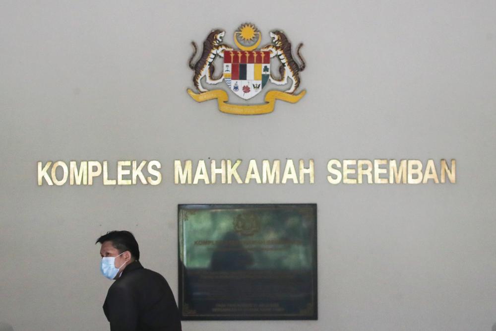 A man wears a face mask at Seremban Court Complex in Negri Sembilan, Aug 24, 2020, during inquest proceedings into the death of Irish-French teenager Nora Anne Quoirin. - EPA