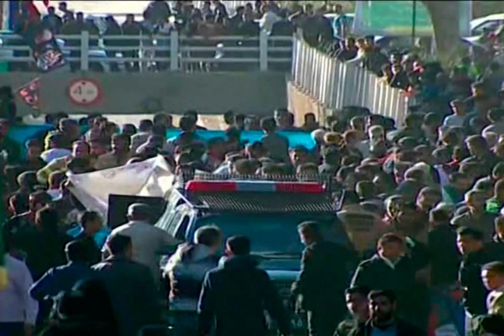 An image grab from a video released by state-run Iran Press news agency on January 3, 2024 shows a police vehicle surrounded by the crowd near the site where two explosions in quick succession struck a crowd marking the anniversary of the 2020 killing of Guards general Qasem Soleimani, near the Saheb al-Zaman Mosque in the southern Iranian city of Kerman/AFPPix