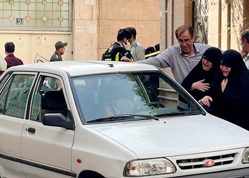 Family members of Colonel Sayad Khodai, a member of Iran's Islamic Revolution Guards Corps, weep over his body in his car after he was reportedly shot by two assailants in Tehran, Iran, May 22, 2022. IRGC/WANA (West Asia News Agency)/Handout via REUTERSpix