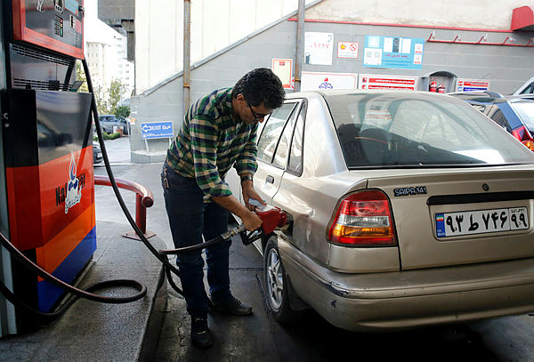 Iranians fill their vehicles at a petrol station in Tehran, on Nov 15. — AFP