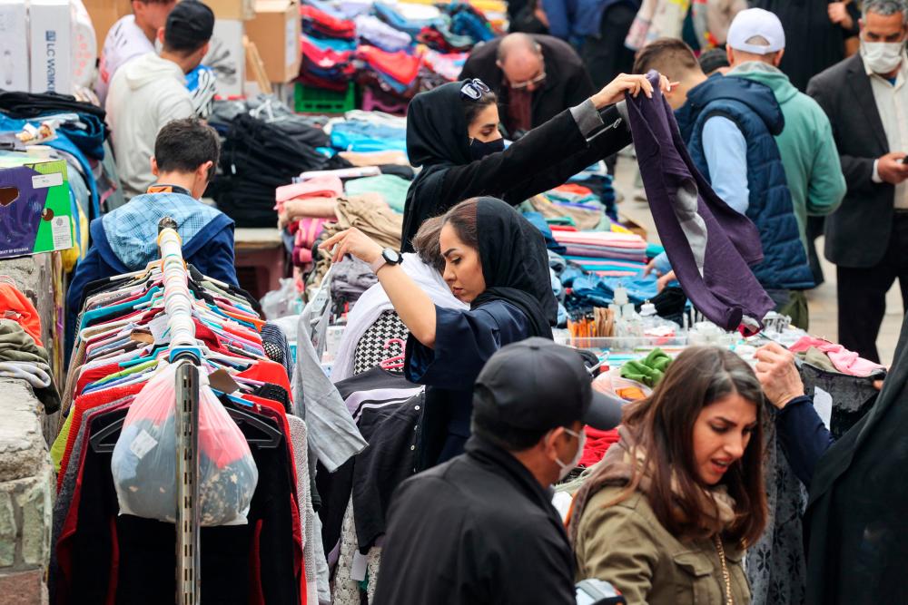 In this picture taken on March 14, 2023, people shop at a market in Tehran ahead of the Nowruz New Year festival. Tehran is emptying ahead of the Persian New Year, as is the case annually, but this time around Iranians are being forced to adapt as the festival coincides with Ramadan. AFPPIX