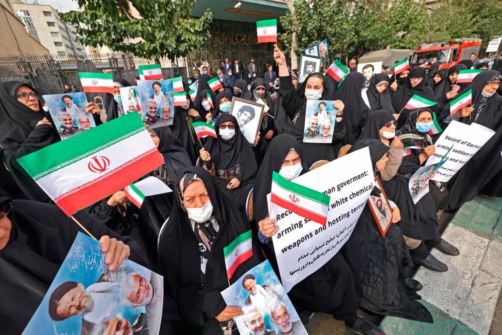 Women protesters gather for an anti-German demonstration, condemning Germany’s support of Berlin-based Iranian opposition TV stations and anti-government protests in Iran, outside the German embassy headquarters in Iran’s capital Tehran on November 1, 2022. AFPPIX