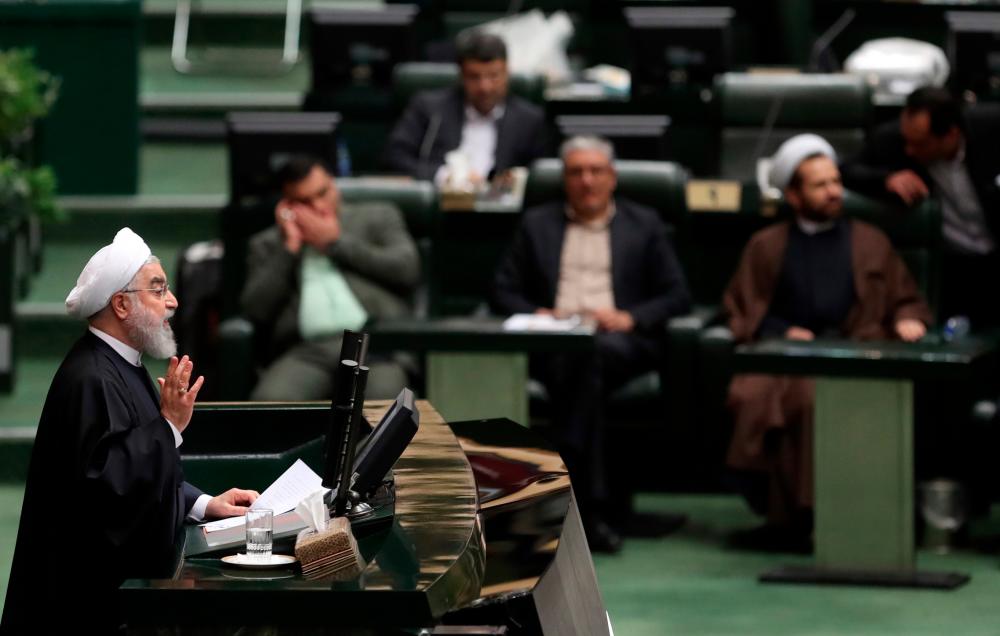 Iran's President Hassan Rouhani (L) delivers a speech to present the budget for the financial year starting late March 2020 to the parliament in Tehran on December 8, 2019. - AFP