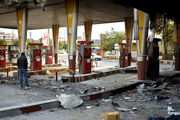 An Iranian man checks a scorched gas station that was set ablaze by protesters during a demonstration against a rise in gasoline prices in Eslamshahr, near the Iranian capital of Tehran, on November 17, 2019. — AFP