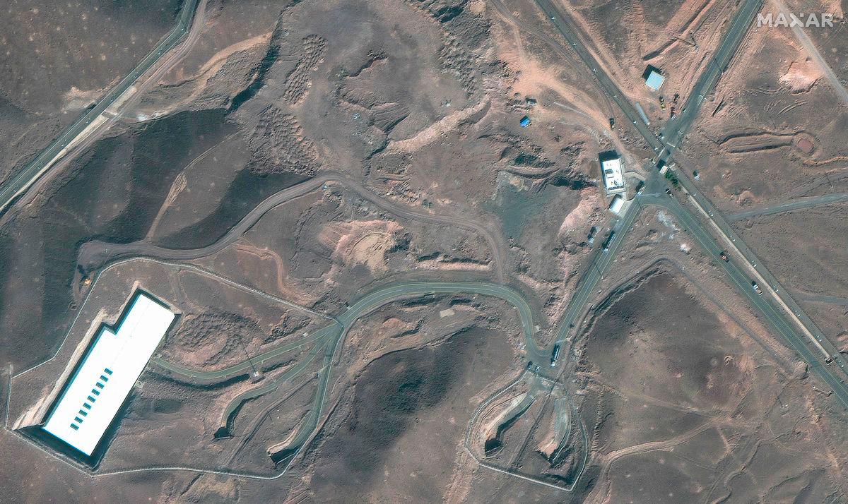 Cargo trucks postioned near an underground entrance to Iran’s Fordow Fuel Enrichment Plant (FFEP), in Fordo, Iran on June 20, 2025. (Photo by SATELLITE IMAGE ©2025 MAXAR TECHNOLOGIES / AFP)
