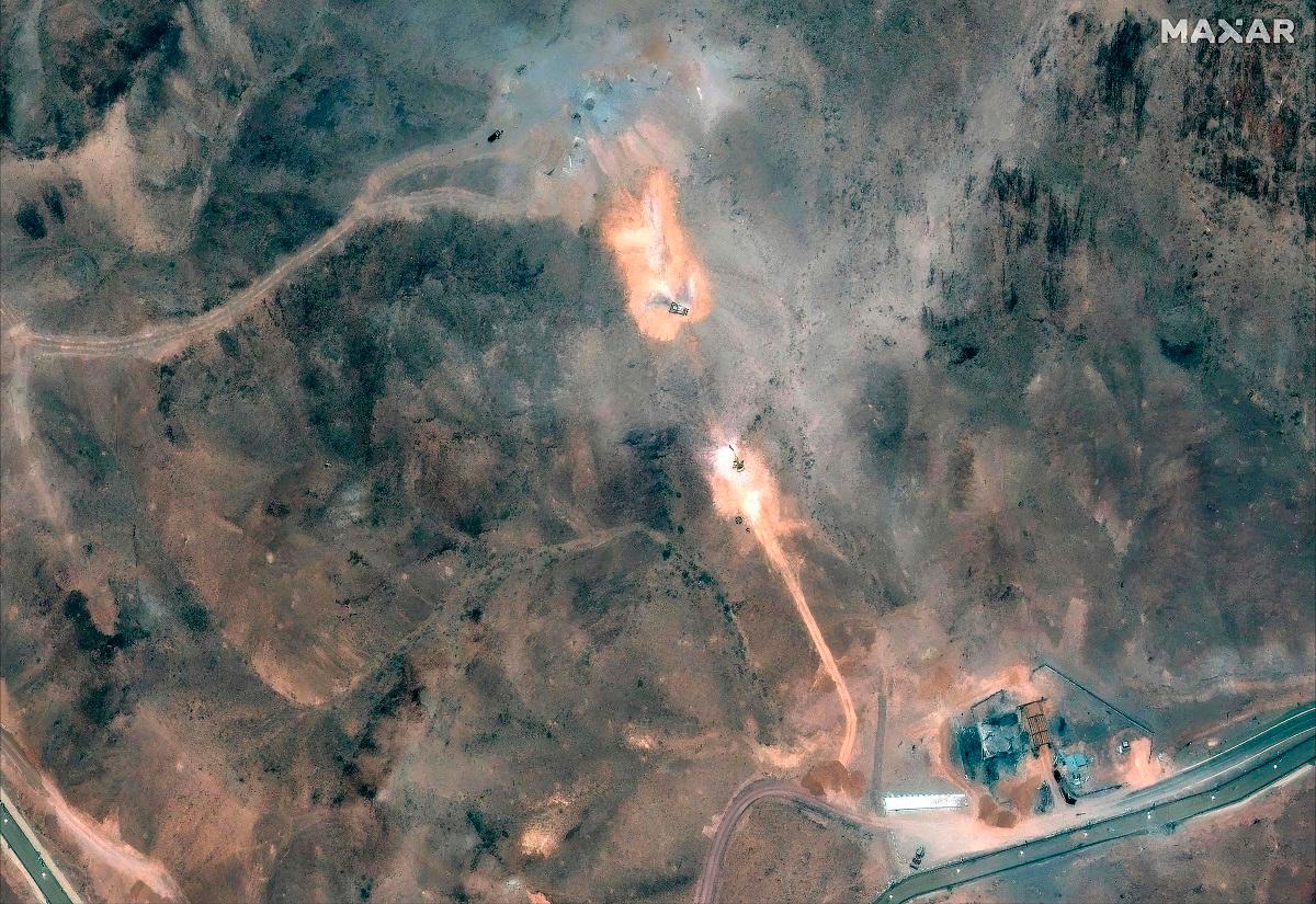 This handout satellite image provided by Maxar Technologies and dated July 1, 2025, shows activity near the perimeter building and southern holes caused by the June 22 US airstrike on the Fordo (Fordow) Fuel Enrichment Plant complex. - AFP PHOTO/ SATELLITE IMAGE ©2024 MAXAR TECHNOLOGIES