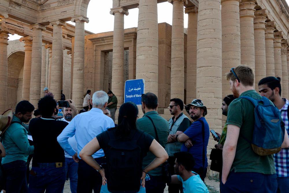 A group of tourists visit the ancient city of Hatra in northern Iraq on September 10, 2022, as local authority initiatives seek to encourage tourism and turn the page on the years of violence by the Islamic State IS group. AFPPIX