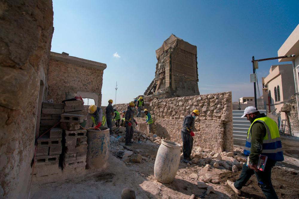 Iraqi builders work on the reconstruction of a traditional house in the old town of Iraq’s northern city of Mosul, on February 23, 2022. AFPPIX