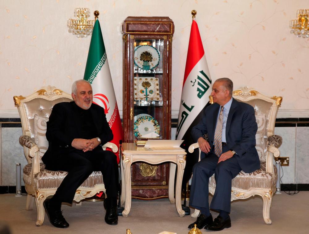 Iraqi Foreign Minister Mohammad Ali al-Hakim (R) meets Iran's Foreign Minister Mohammad Javad Zarif in Baghdad on May 26, 2019. - AFP