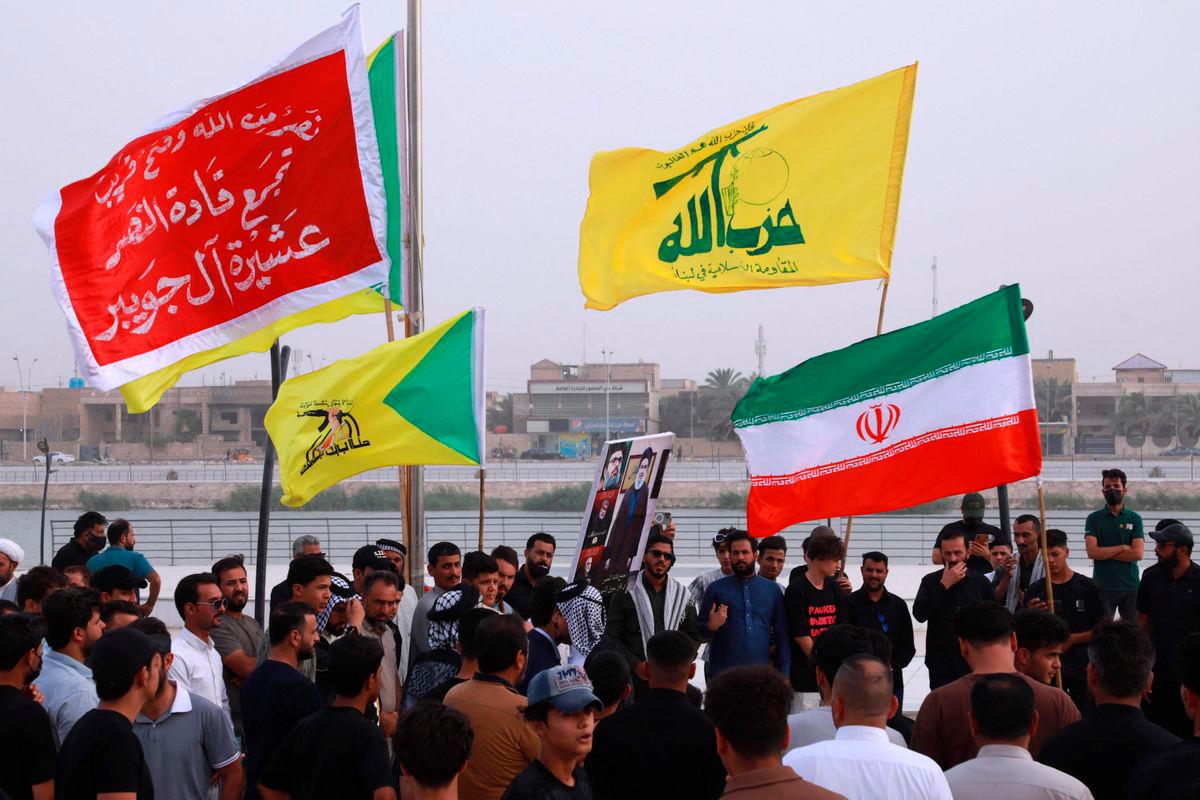 Supporters of Iraq’s Hezbollah Brigades attend a gathering to condemn Israel’s attack on Iran in the city of Nasiriyah. AFP