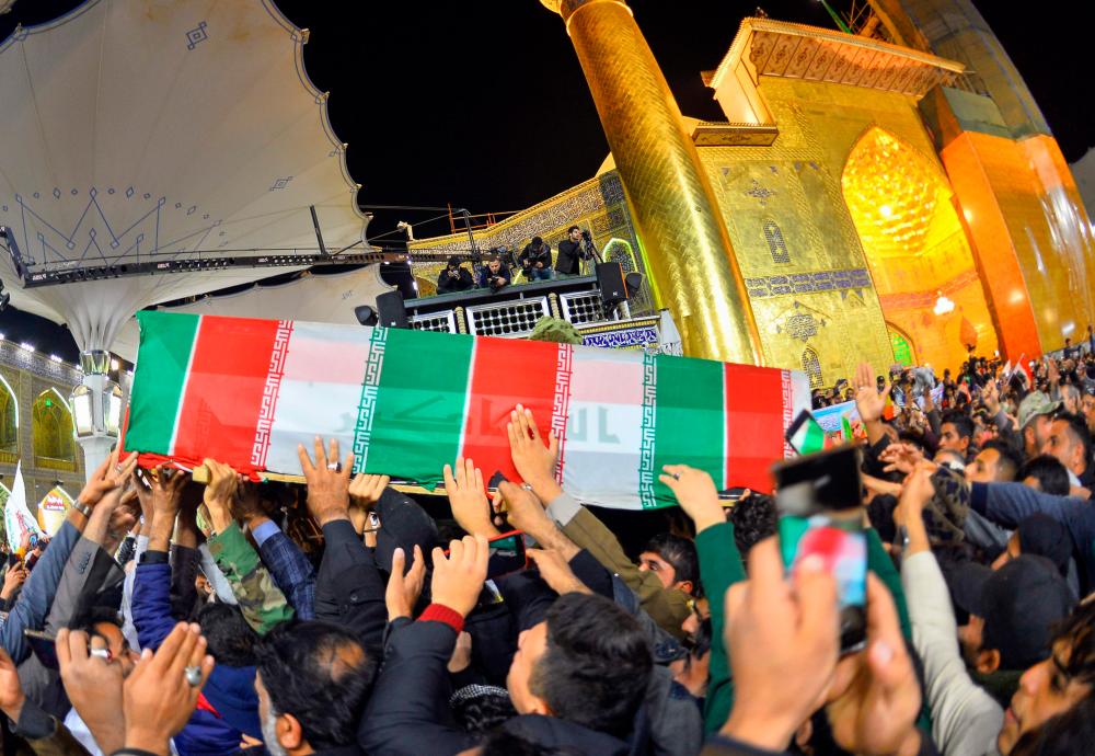 Mourners carry the coffins of slain Iraqi paramilitary chief Abu Mahdi al-Muhandis, Iranian military commander Qasem Soleimani and eight others towards the Imam Ali Shrine in the shrine city of Najaf in central Iraq during a funeral procession on January 4, 2020. - AFP