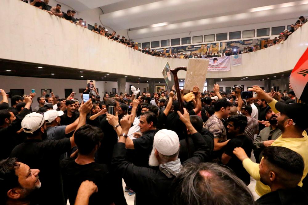 Supporters of Iraqi cleric Moqtada Sadr, protesting against a rival bloc’s nomination for prime minister, gather inside Iraq’s parliament in the capital Baghdad’s high-security Green Zone, on July 31, 2022, a day after storming it. AFPPIX