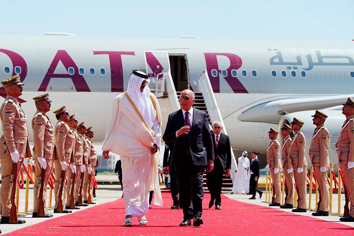 Iraq’s Foreign Minister Fuad Hussein (R) walks with Qatar’s Emir Sheikh Tamim bin Hamad al-Thani as he arrives in Baghdad ahead of the 34th Arab League summit on May 17, 2025. AFPpix