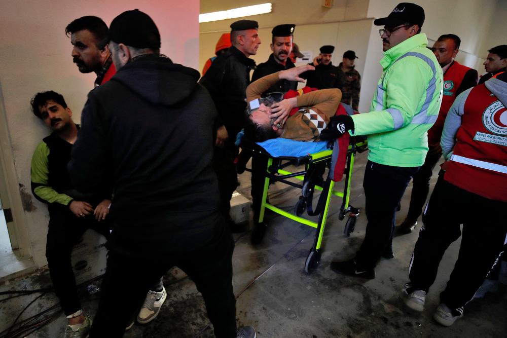 Injured football spectators are brought into an emergency area at the Basra International Stadium following a stampede ahead of this evening's final match of the Arabian Gulf Cup/AFPPIX