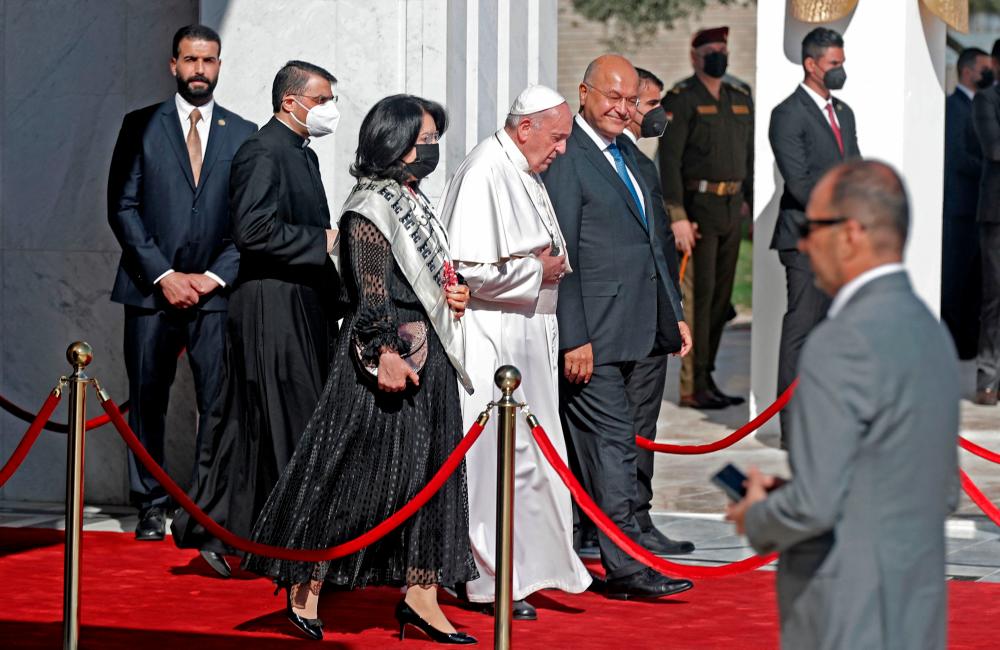 Iraq's President Barham Saleh (C-R) and his wife Sarbagh (C-L) escort Pope Francis (C) during the farewell ceremony for the pontiff at the Iraqi capital's Baghdad International Airport on March 8, 2021. — AFP