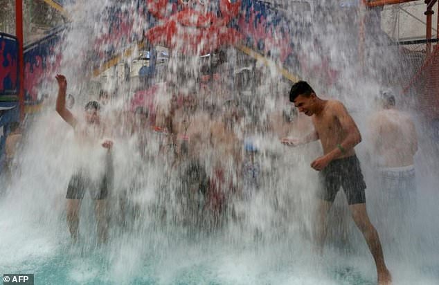 Iraqis cool themselves off at an indoor water park during a heat wave in the capital Baghdad.