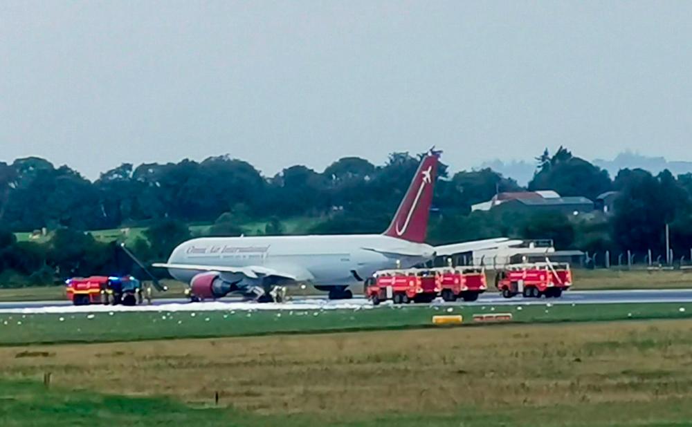 Firecrews attending to an Omni Air International aircraft on the tarmac at Shannon Airport in County Clare, mid-west Ireland, on August 15, 2019 after the incident. — AFP