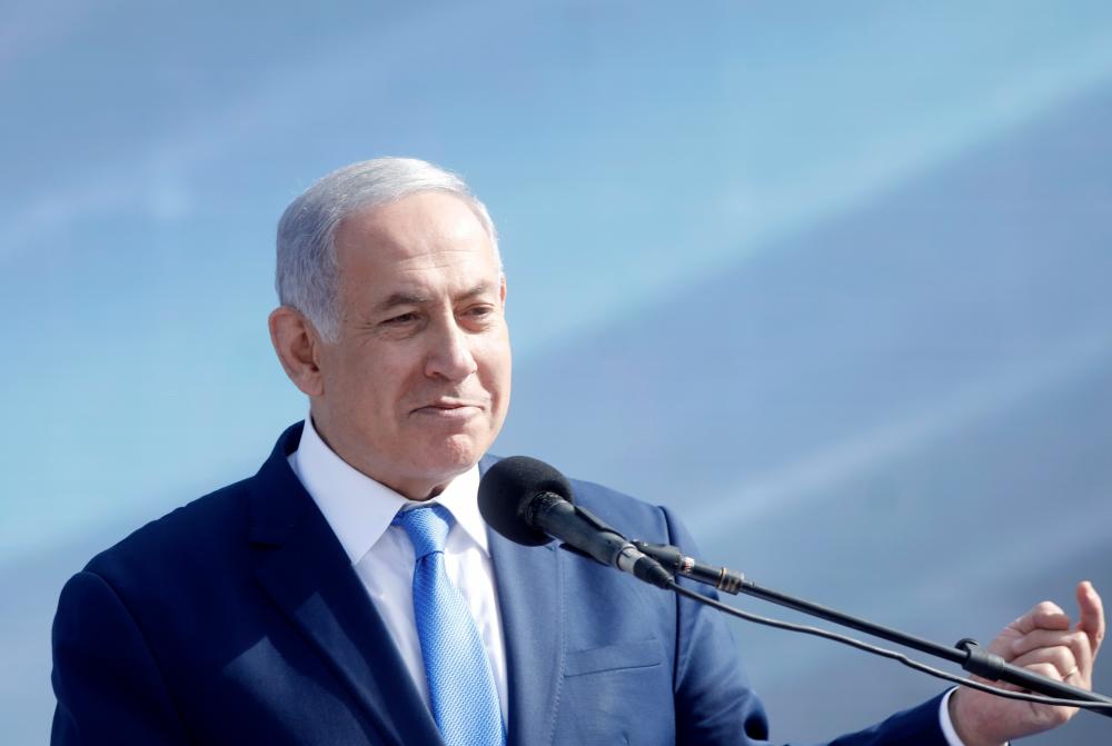 Israeli Prime Minister Benjamin Netanyahu(C) gives a speech during the inauguration of the new international Ramon Airport, located some 18km north of the southern Israeli Red Sea resort city of Eilat, on Jan 21, 2019. — AFP