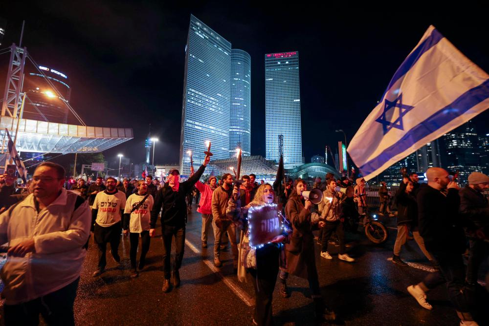 Israeli left wing protesters attend a rally against Prime Minister Benjamin Netanyahu's new hard-right government in the coastal city of Tel Aviv on January 14, 2023. - AFPPIX