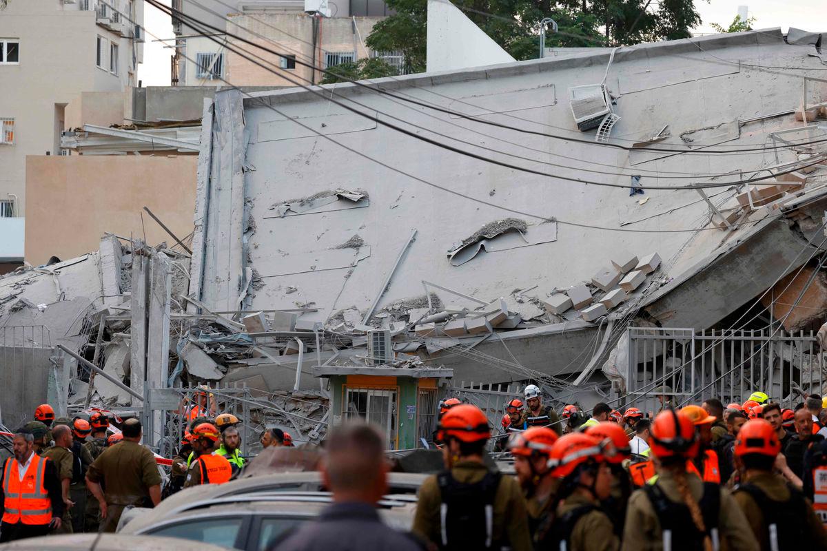 Israeli rescuers search through the rubble at the site of an Iranian missile strike in Bnei Brak on June 16, 2025. Iran unleashed a barrage of missile strikes on Israeli cities early on June 16, after Israel struck military targets deep inside Iran, with both sides threatening further devastation. AFP