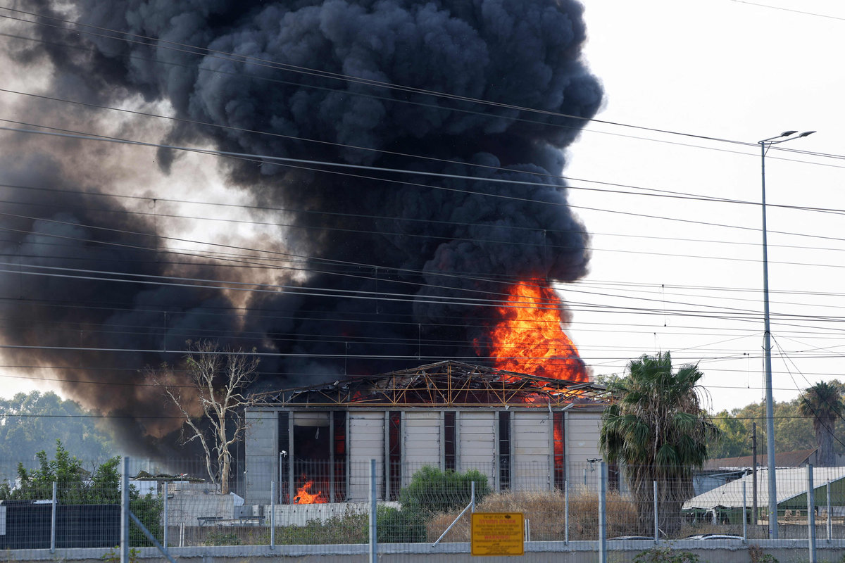 Smoke billows from a fire in a building in Herzliya near Tel Aviv following a fresh barrage of Iranian rockets on June 17, 2025. - AFPpix
