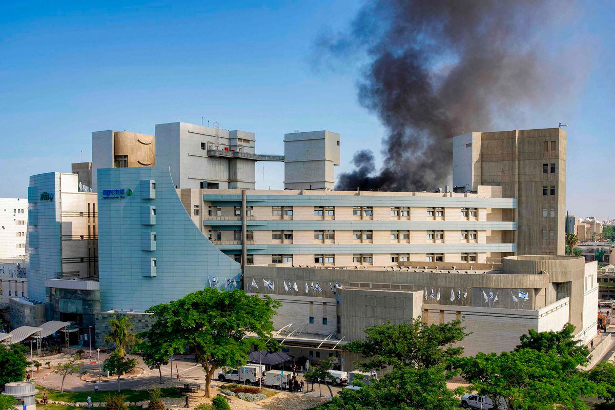 Smoke billows from a building at Soroka Hospital in Beersheba in southern Israel following an Iranian missile attack - AFPPIX