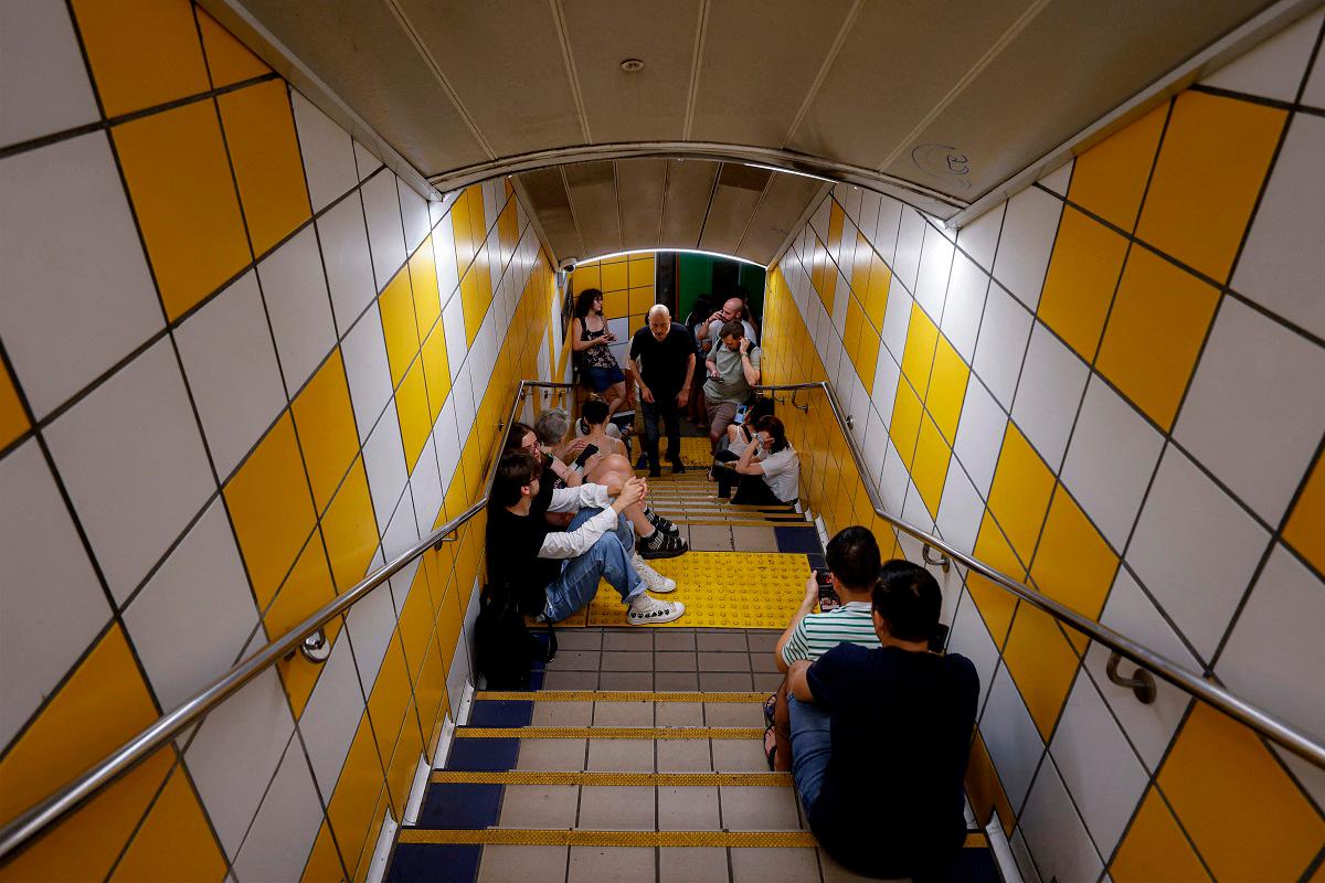 People take shelter for the night at a station of the Carmelit underground funicular railway in Israel’s northern city of Haifa on June 17, 2025 amidst fears of an Iranian missile attack. - Jalaa MAREY / AFP
