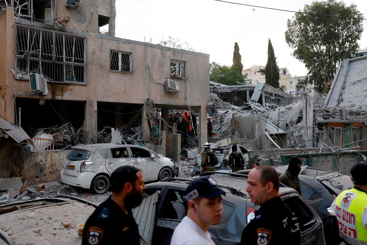 Rescuers work near a damaged building following a strike by an Iranian missile in the Israeli city of Bnei Brak, east of Tel Aviv, on June 16, 2025. Israel's military warned on June 16 of a new missile salvo incoming from Iran, as AFP journalists reported loud explosions in Jerusalem and fires outside the coastal city of Haifa. A short while ago, the IDF identified missiles launched from Iran toward the territory of the State of Israel, the army posted on Telegram, using the acronym for its official name. - Jalaa MAREY / AFP