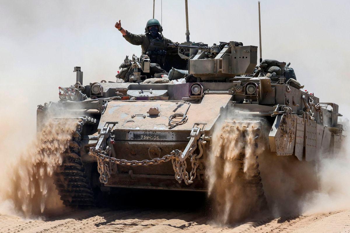 An Israeli soldier gestures atop a military vehicle at Israel’s southern border with the Gaza Strip on May 20, 2025. AFPpix