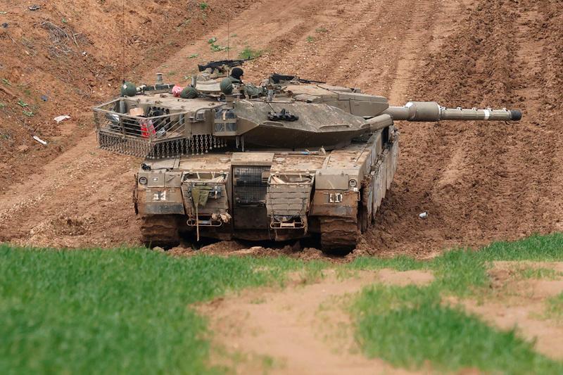 This picture taken from the Israeli side of the border with the Gaza Strip shows an Israeli army tank stationed on a hill overlooking northern Gaza on February 12, 2025, amid a truce in the war between Israel and Hamas. Mediators Qatar and Egypt were pushing to resolve a crisis in the Gaza ceasefire, a Palestinian source told AFP, after Israel and the United States told Hamas to release hostages this weekend or face a return to war. - Menahem KAHANA / AFP