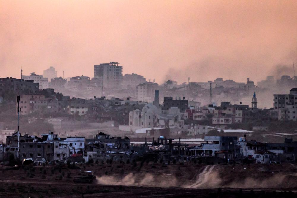 This picture taken from southern Israel near the border with the Gaza Strip shows an Israeli tank making its way into north Gaza on November 22, 2023, amid ongoing battles between Israel and the Palestinian Hamas movement. - AFPPIX